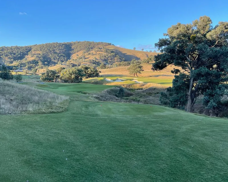 A golf course fairway and green in the hills at golden hour, where Michael worked as a development manager