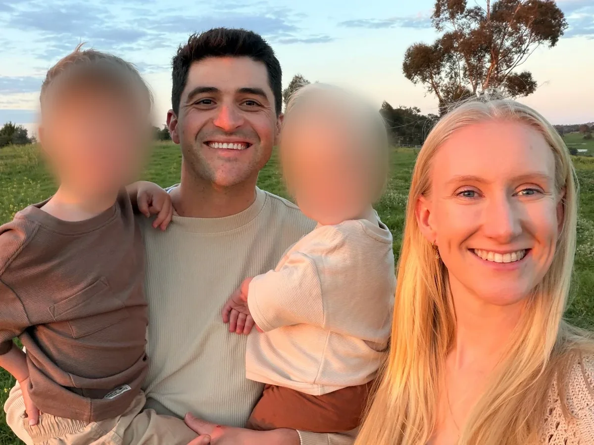 Michael with his family in a paddock near Melbourne at sunset (children's faces blurred for privacy)